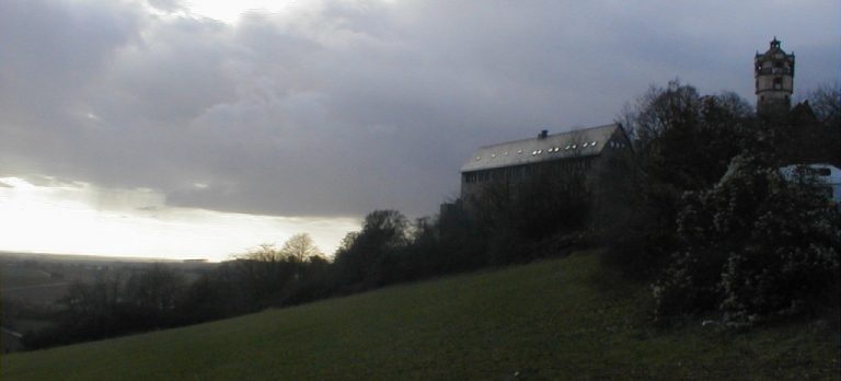 A castle in Germany on the top of a hill on a grey day