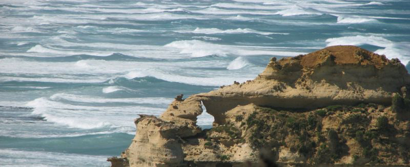 The southern waves lapping the stones of the 12 Apostles in Victoria, Australia, slowly eroding and destroying them.