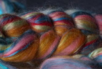 Colourful wool fiber waiting to be spun on the spinning wheel