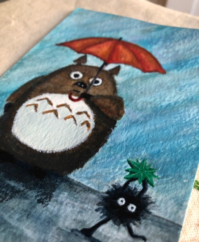 A watercolour postcard of Totoro and a soot sprite in the rain