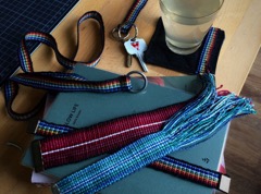 Handwoven inkle bands sewn into various products - bookmarks, key fobs, lanyards and more